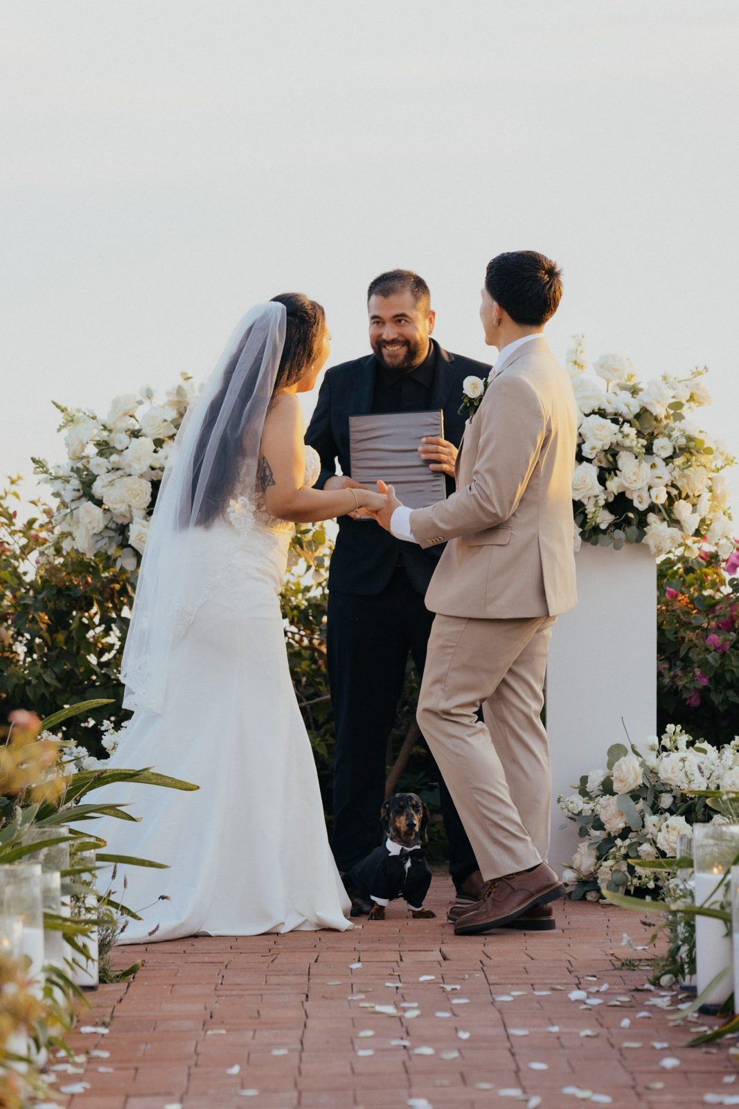 Officiant laughing with the couple during vows
